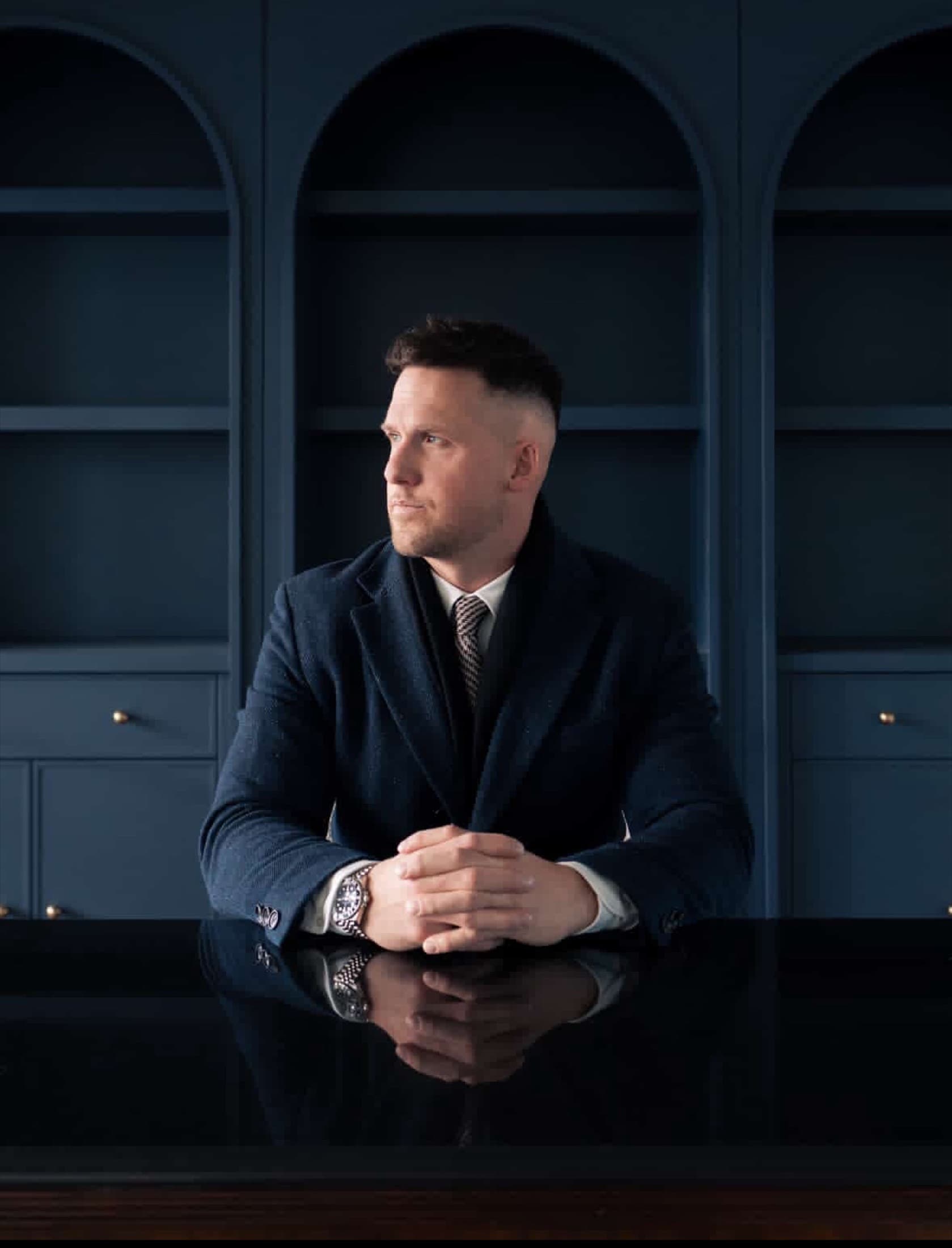 Max Mills, founder of WESTMILLS Real Estate, in the brand's signature navy